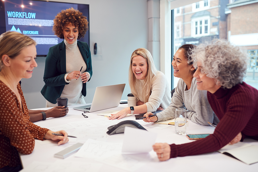  Businesswoman Leads Creative Meeting Of Women Collaborating Around Table In Modern Office