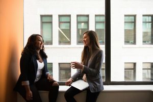 two people smiling and talking 