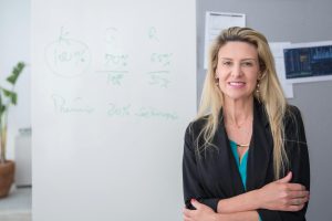 woman leaning against a wall in an office