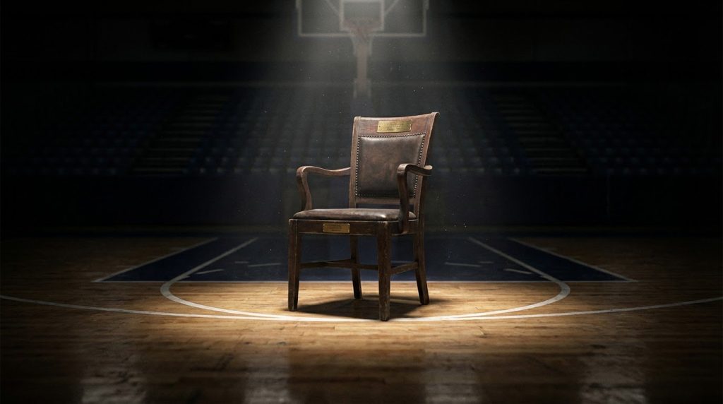 chair in the center of an empty gymnasium